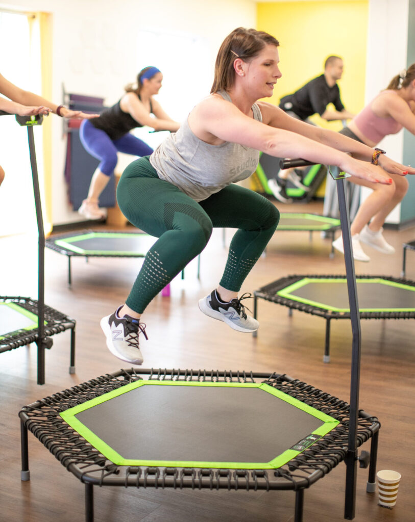Clients participating in a Jumping Fitness class. Jumping on a mini trampoline