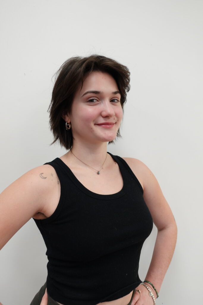 Headshot of instructor Natalia Young. Short brown hair, smiling without showing teeth, wearing a black tank top.